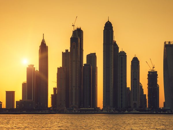 View of Dubai with sun at sunrise, UAE.